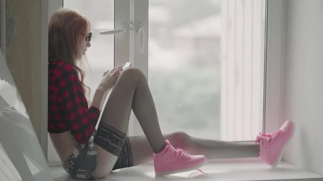 Young girl hipster in checkered shirt, shorts and pantyhose