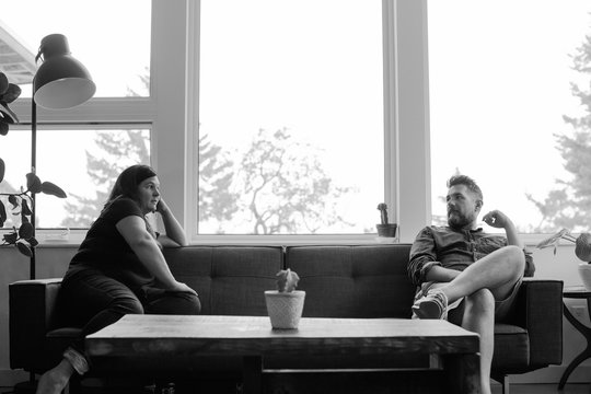 Unhappy couple at home on couch in silence