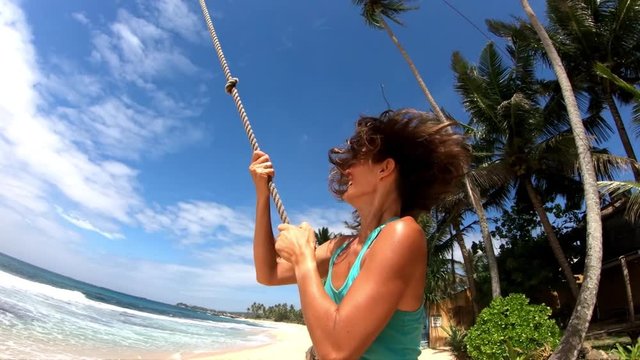 Woman enjoy bungee jumping on the beach at sunny day gopro slow motion