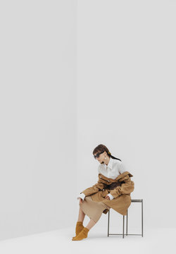 Trendy female / fashion model in abstract white space.