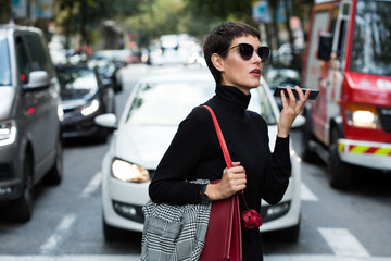 Stylish short haired business woman commuting between meetings on a busy city