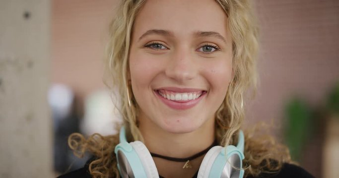 portrait of happy young woman smiling enjoying relaxed carefree lifestyle caucasian female college student looking at camera