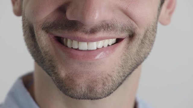 close up young man mouth smiling happy with beard dental health concept half face