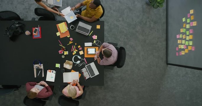 professional multi ethnic team brainstorming business proposal planning creative strategy in office meeting workplace colleagues collaborating above view