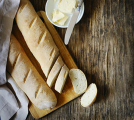 Fresh homemade bread and butter on wooden table