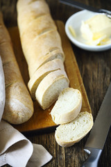 Fresh homemade bread and butter on wooden table