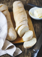 Fresh homemade bread and butter on wooden table