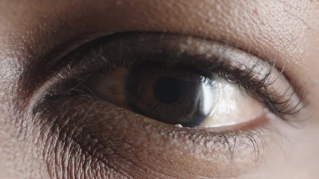 close up african american man eye looking blinking optical detail 