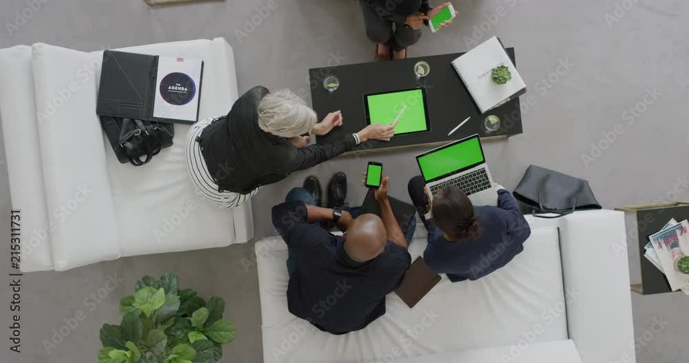 Wall mural professional business people brainstorming innovative ideas for startup company viewing green screen