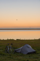 Naklejka premium Touristic camp with bicycle and sunrise in summer ,Iceland.