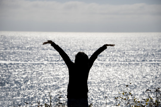 Silhouette Of Cheering Woman In Front Of The Sea