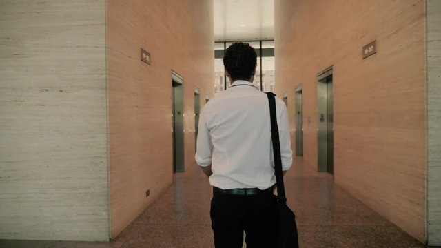 Confident Young Professional Walks Into Office Building Ready for First Day of New Job, Towards Elevators of Large Skyscraper in Financial District, Slow Motion 4K 60 FPS