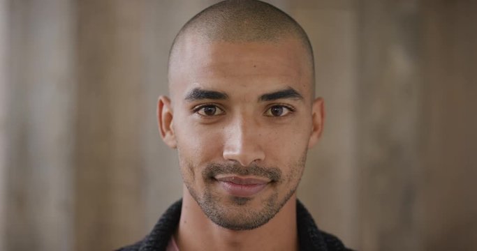 Close Up Portrait Of Attractive Young Hispanic Man Smiling Enjoying Happy Lifestyle Looking At Camera Wooden Background Slow Motion