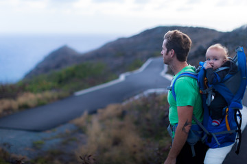 A father hiking on a trail with his kid. Sceanic ocean view. Staying fit. Healthy lifestyle.