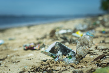 Trash and plastic lying on the beach. Plastic in the ocean. Littering.