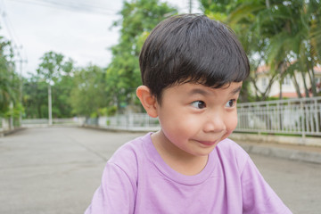 Asian boy with funny face on street.