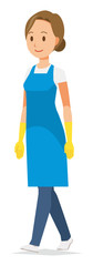 A woman wearing a blue apron and rubber gloves is walking