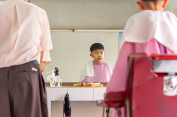 young asia boy at barber shop .