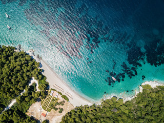 Early morning sunrise on the private beach on the island of Skopelos in Greece. Perfect aqua water...