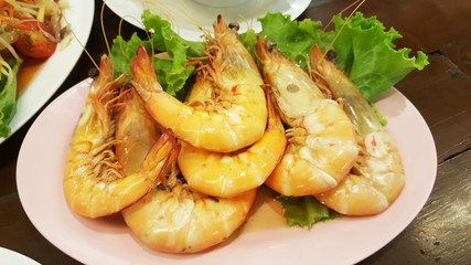 roasted shrimps in plate on table wood