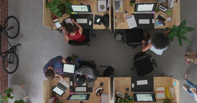 top view young multi ethnic business team in lively office workspace diverse employees interacting discussing startup work strategy time lapse
