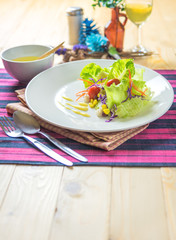 Fresh healthy salad on wooden table.