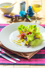 Fresh healthy salad on wooden table.