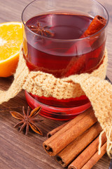Glass of mulled wine wrapped scarf with fresh fragrant spices