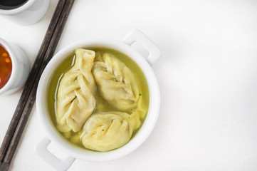 Asian meat dumpling with a drop of chili sauce. Close up. Selective focus