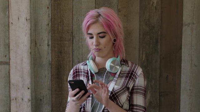 young punk girl portrait of attractive woman with pink hairstyle posing taking selfie photo using smartphone camera technology