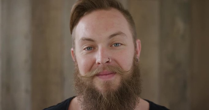 close up young hipster punk man with beard smiling happy enjoying successful lifestyle handsome independent male 