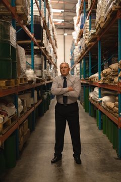 Male manager standing with arms crossed