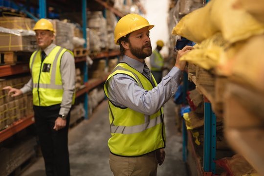 Staff checking stocks in warehouse