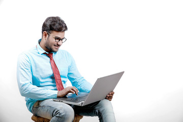 Young indian male using laptop