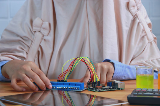 STEM education Laboratory. Beautiful muslim coding a meta program it on the computer.electronic board that can be programmed.technology,Mathematics. science. engineering.