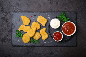Fried crispy chicken nuggets with popular sauces