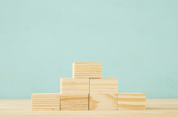 wood blocks stacking as step stairs. success and development concept.