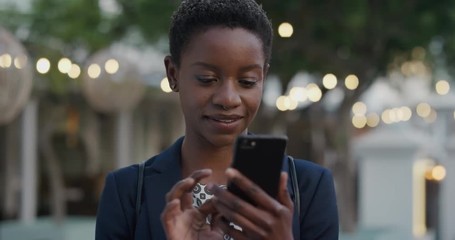 portrait professional african american business woman using smartphone browsing online enjoying reading messages on mobile phone in city - Powered by Adobe