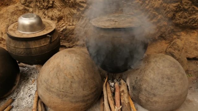 cooking with local traditional africa cooking pot made of clay