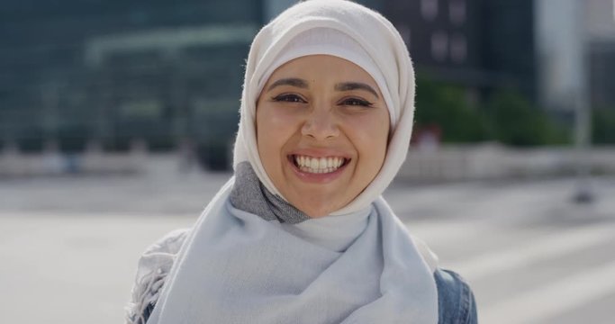 portrait young happy muslim woman smiling enjoying successful urban lifestyle independent female student wearing hijab headscarf in city real people series