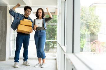 Worker In Warehouse Checking Boxes Using Digital Tablet.Start up small business entrepreneur SME or freelance man and woman working  at home concept, Young Asian small business owner,online marketing.