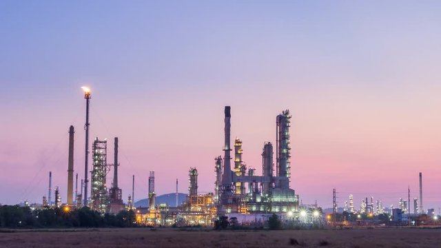 Time lapse of oil refinery petrochemical industry plant at twilight sunset, day to night
