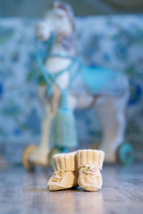 Knitted booties lie on the floor