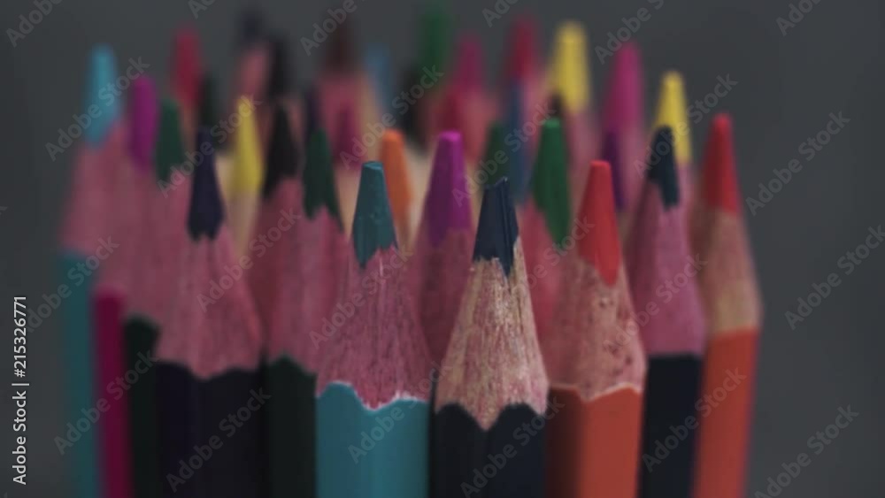 Poster colored pencils, rotation 360 degrees. dark bacground. macro view.