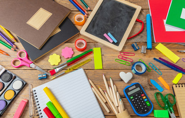 Back to school. School supplies on wooden background