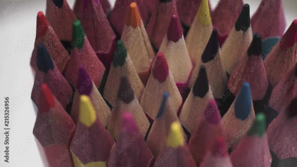 Poster colored pencils, rotation 360 degrees. dark bacground. macro view.