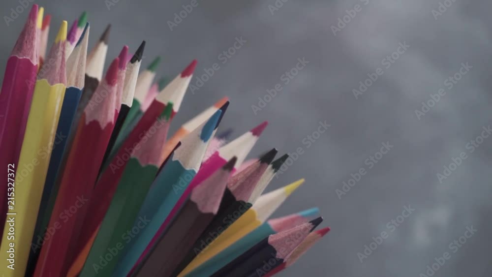 Poster colored pencils, rotation 360 degrees. dark bacground. macro view.