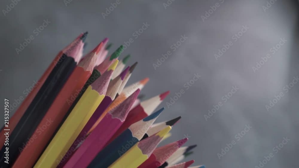 Poster colored pencils, rotation 360 degrees. dark bacground. macro view.