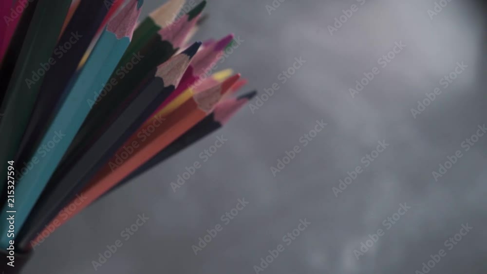 Poster colored pencils, rotation 360 degrees. dark bacground. macro view.