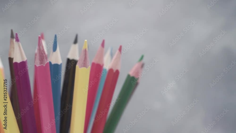 Poster colored pencils, rotation 360 degrees. dark bacground. macro view.
